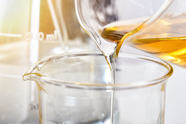 liquid being poured into a beaker