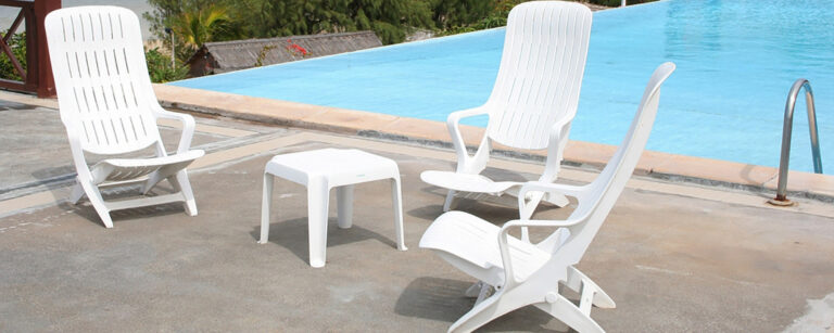 Plastic patio chairs beside a pool
